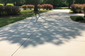 Concrete driveway with expansion joints in a Greensboro neighborhood, highlighting durability and design