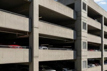 Modern concrete parking garage in Greensboro, NC, highlighting architectural design and vehicle parking