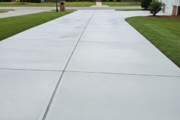 Newly installed concrete driveway in Greensboro, NC, showcasing smooth finish and suburban charm